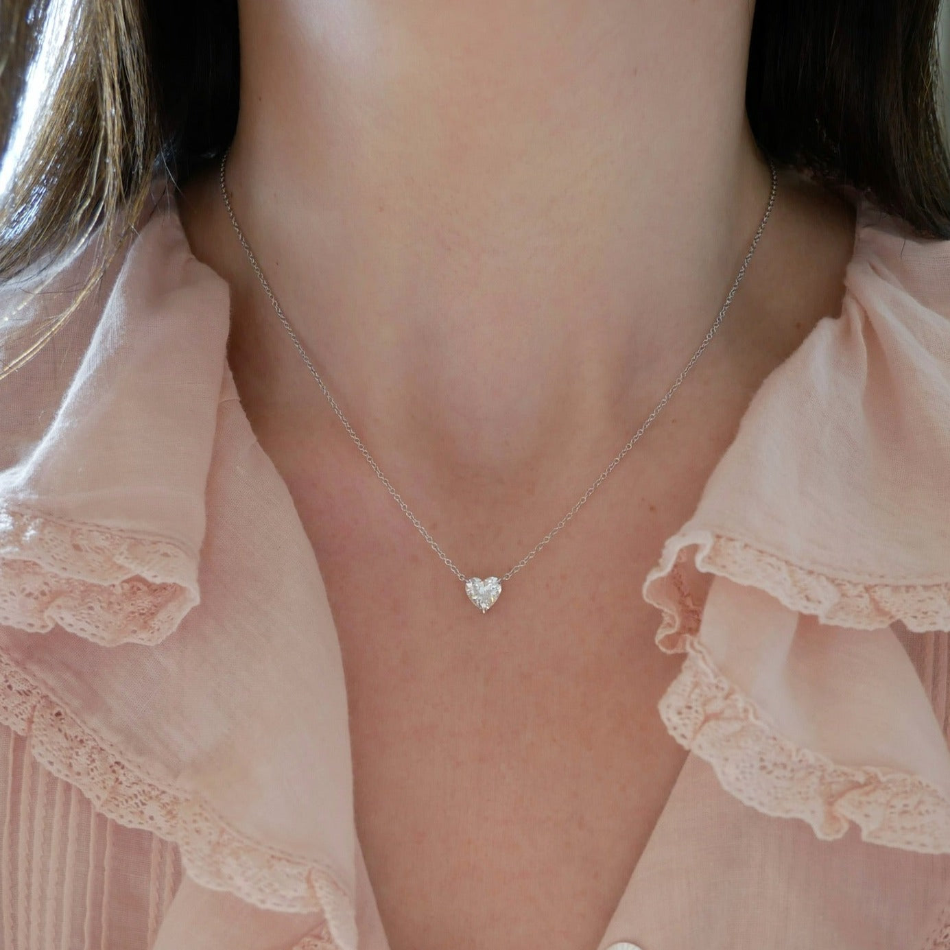 Diamond Heart Solitaire Necklace in 14k white gold with 1.02 carat heart shaped diamond styled on neck of model