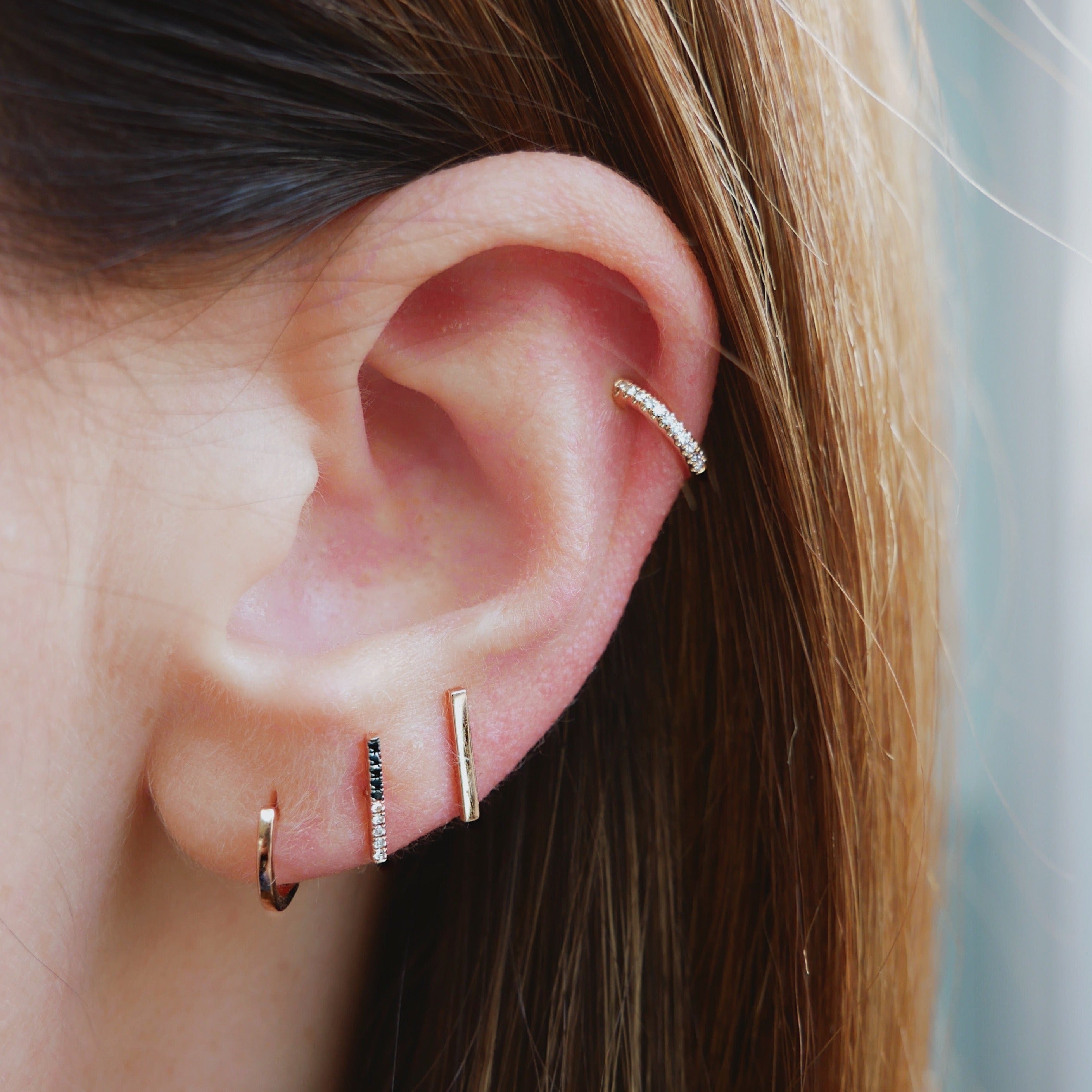 2 Tone Diamond Bar Stud Earring in 14k Yellow Gold Styled on Ear