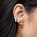 Diamond Mini Huggie with Ruby Heart Drop Earring in 14k yellow gold styled on first earring hole on ear lobe of model with heart huggie and heart stud