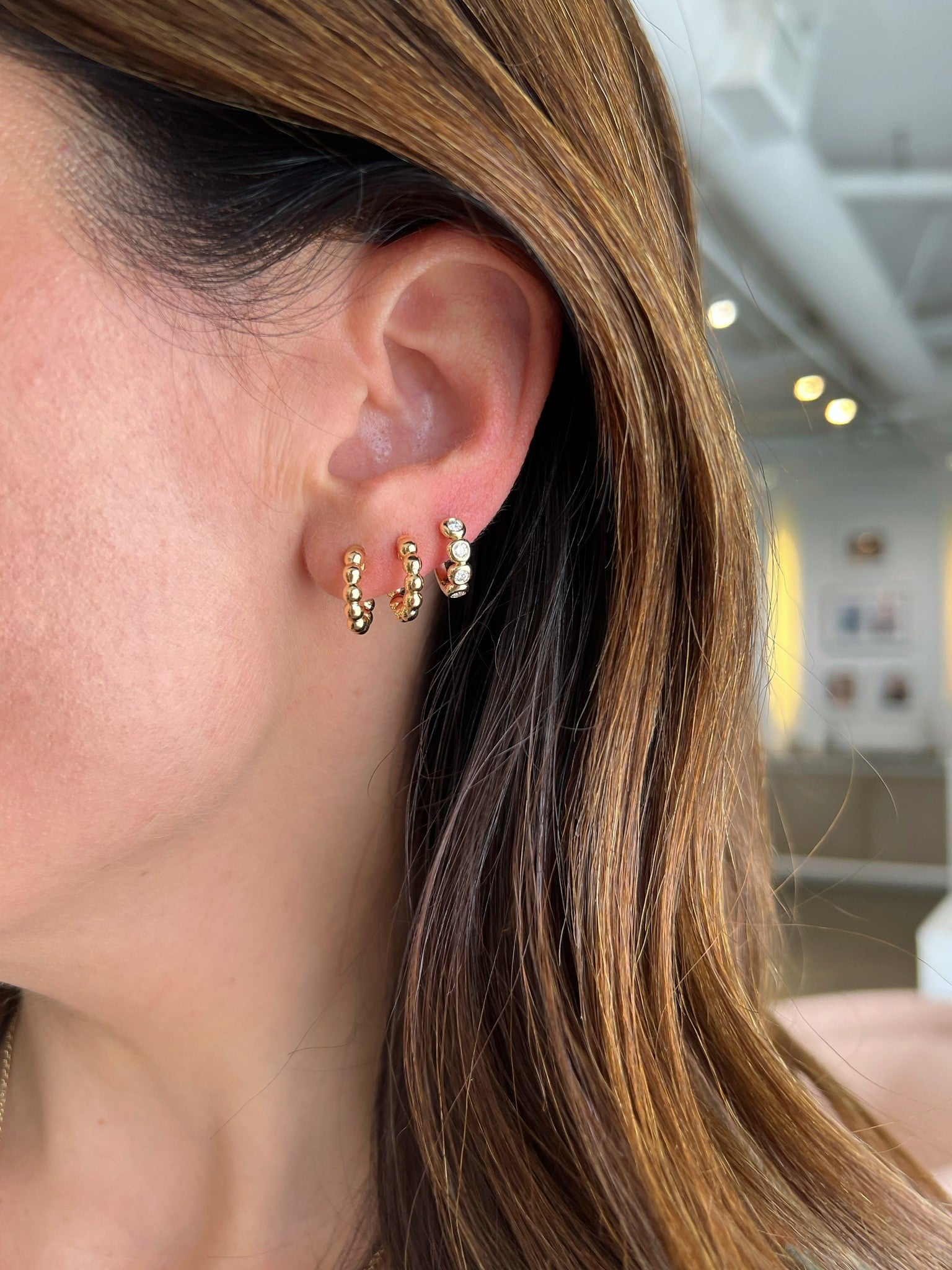 14k Yellow Gold Ball Hoop on Ear with Pillow Huggie