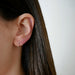 Diamond Chevron Huggie Earring in 14k yellow gold styled on ear of model