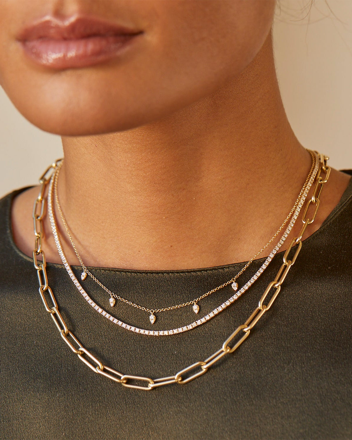 Diamond Grace Necklace styled on neck of model with layered necklaces and model in black blouse