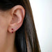 Diamond Wine Enamel Huggie Earring in 14k yellow gold styled on ear lobe of model