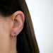 Diamond Olive Enamel Huggie Earring in 14k yellow gold styled on ear lobe of model