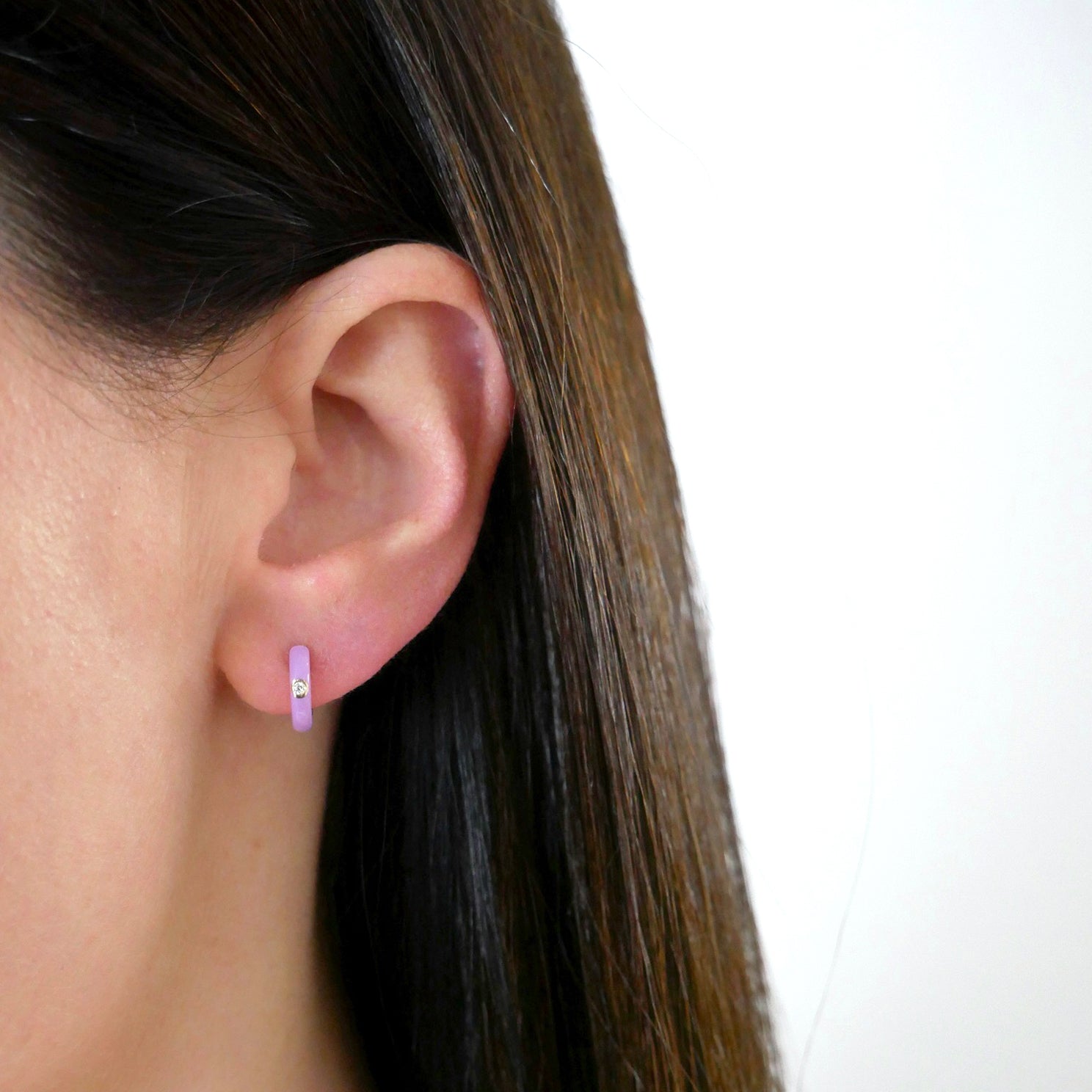 Diamond Lavender Enamel Huggie Earring in 14k yellow gold styled on ear lobe of model
