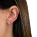 Baby Diamond Moon Stud Earring in 14k yellow gold styled on ear lobe of model next to blue enamel huggie with one diamond