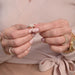 Model Putting on the Diamond Heart Signet Ring in 14k Yellow Gold to the Pinky Finger and Wearing a Pink Sweater - No Audio