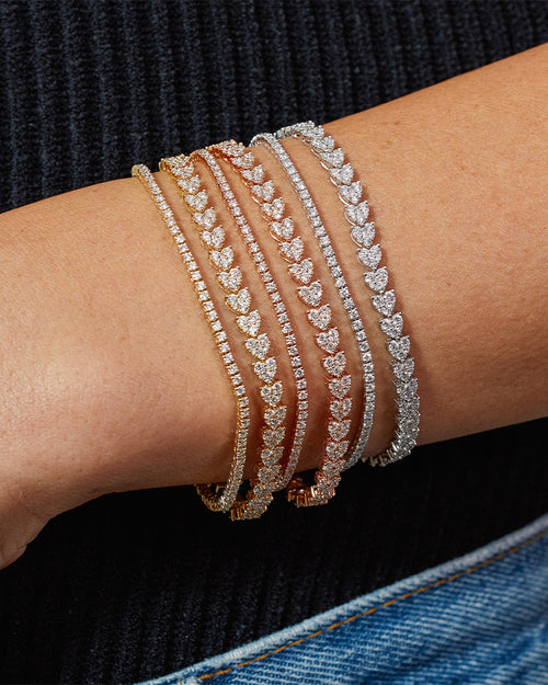 Endless Love Eternity Bracelet styled on the wrist in white gold, rose gold, and yellow gold, styled next to diamond tennis bracelets