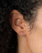 Diamond Mini Lightning Bolt Stud Earring in 14k yellow gold styled on ear lobe of model