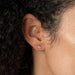 Diamond Mini Lightning Bolt Stud Earring in 14k yellow gold styled on ear lobe of model